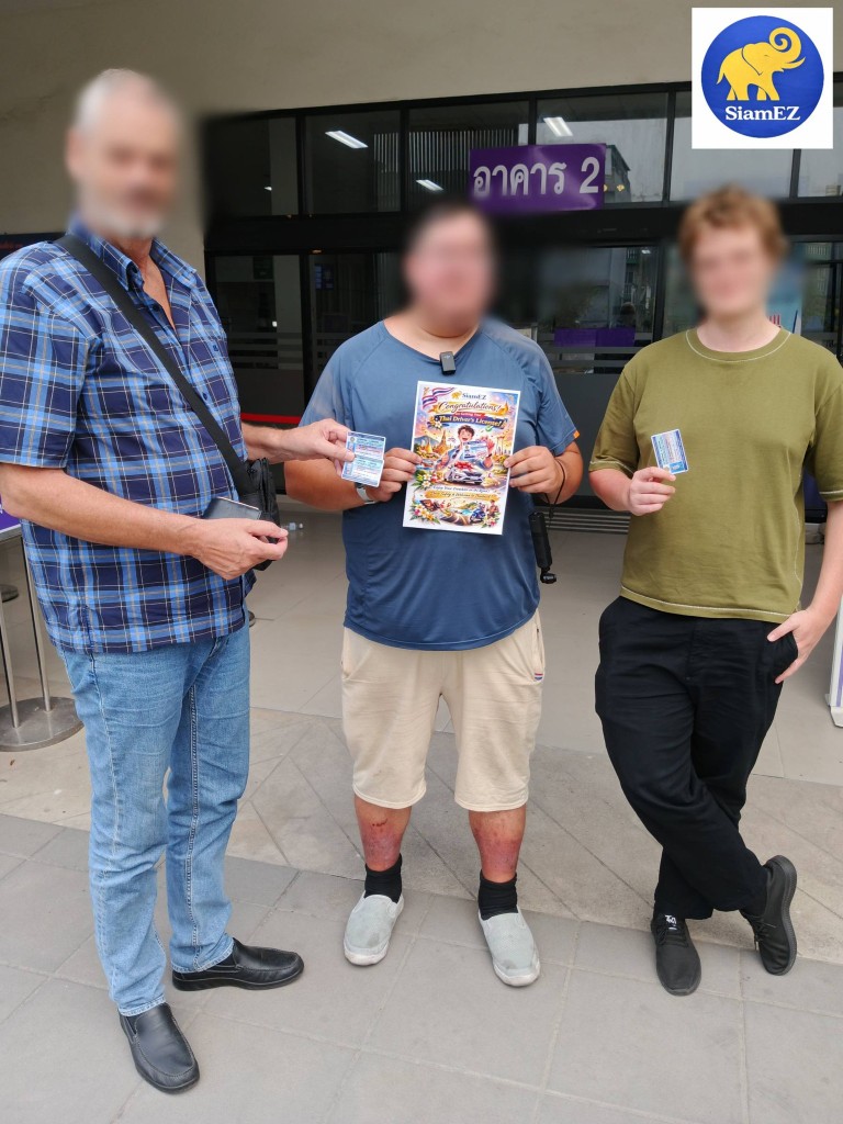 Three happy customers holding their new Thai driver's licenses and a SiamEZ congratulatory flyer in front of a government building.
