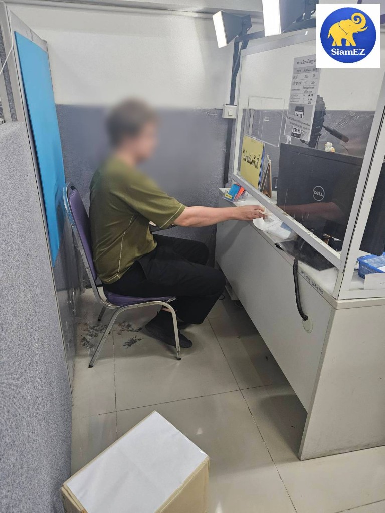 A customer at the SiamEZ service counter for Thai license assistance.